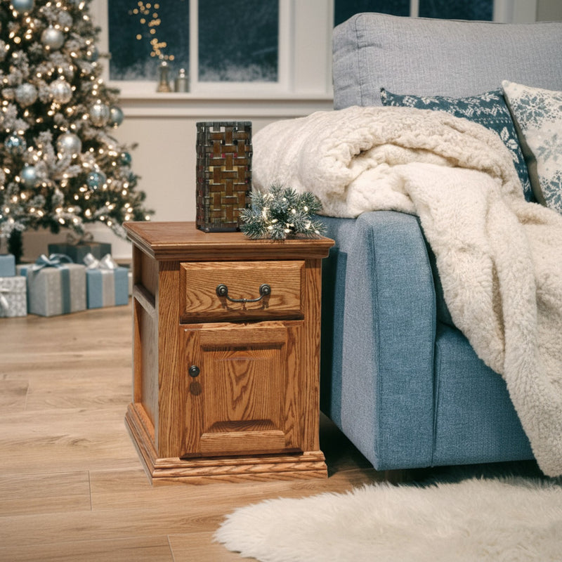 Traditional Oak End Table O-T250 beside a blue sofa and Christmas tree, showcasing its warm solid wood finish and classic drawer design.