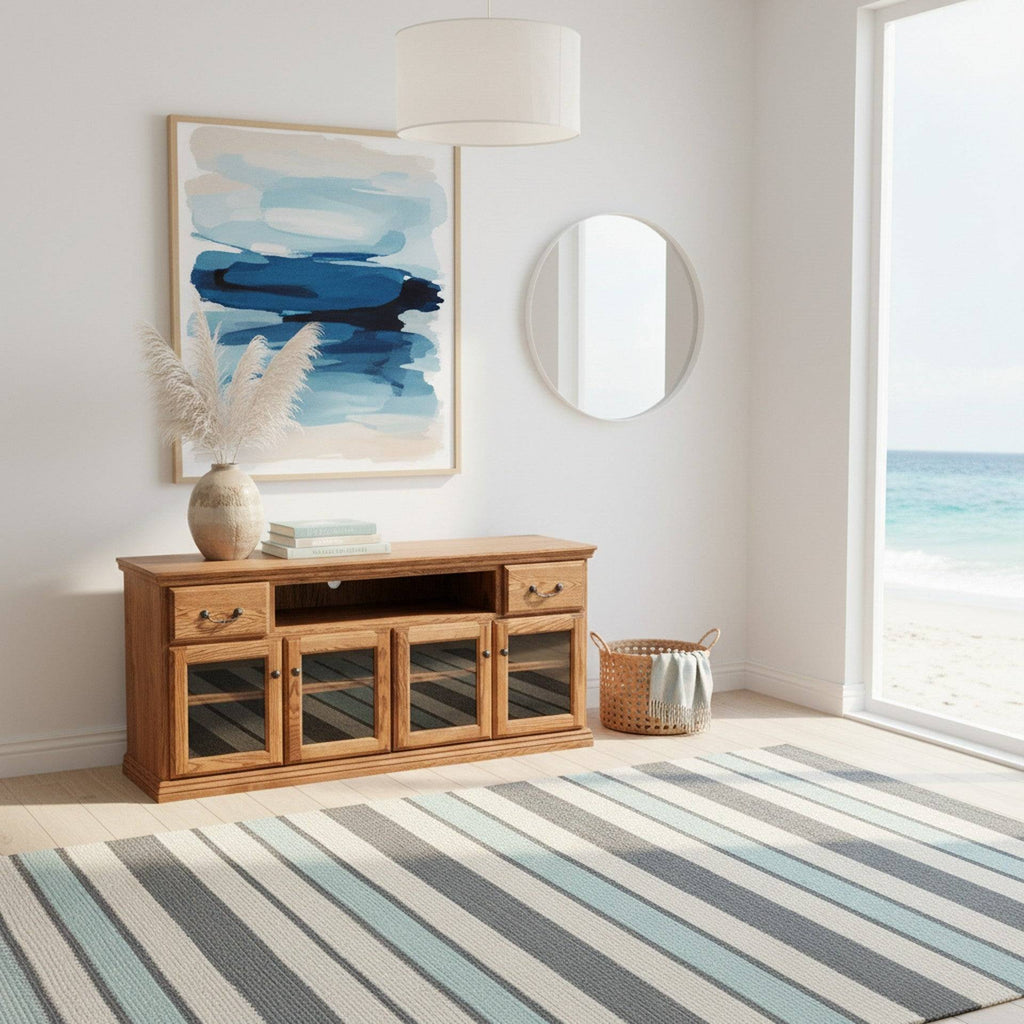 Traditional Alder 65" TV Stand in oak finish with glass door cabinets, styled in a coastal living room with ocean view and modern decor.