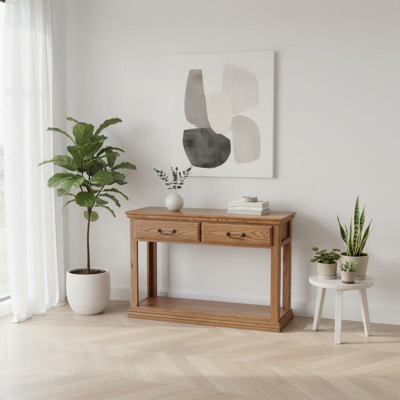 Traditional Oak Sofa Console Table O-T247 placed in a modern white interior with plants and abstract art, emphasizing its solid wood build and versatility.