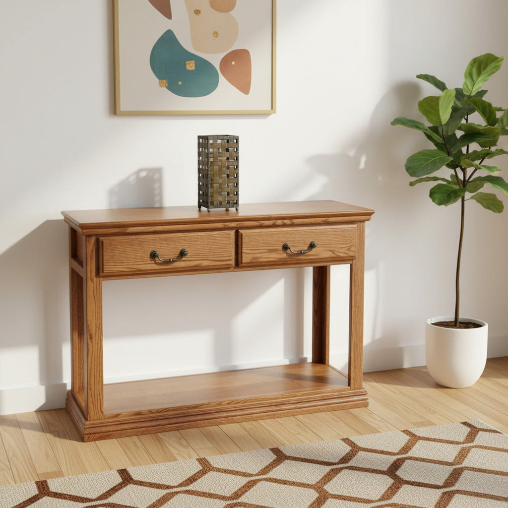 Traditional Oak Sofa Console Table O-T247 with two drawers and lower shelf in a modern living room with abstract wall art and indoor plant.