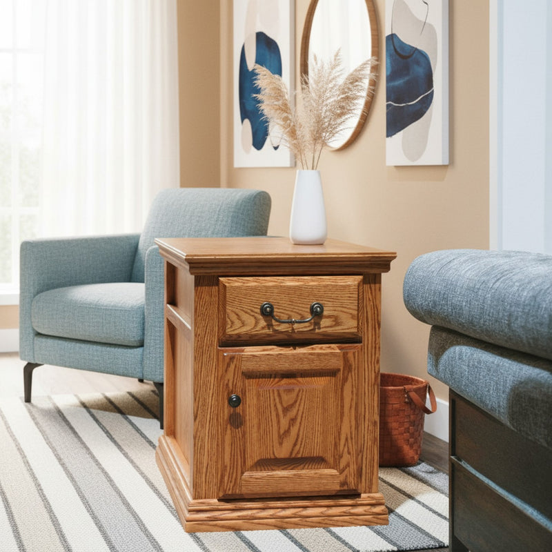 Traditional Oak End Table O-T250 in a cozy corner with blue chair and striped rug, featuring solid wood build and classic drawer pull.