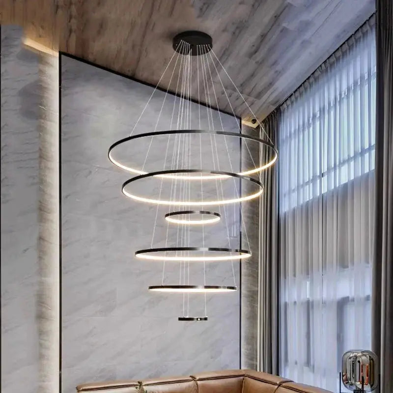 Tiered circular pendant chandelier in black finish, ideal for Nordic-style home interiors and stairwell lighting solutions.