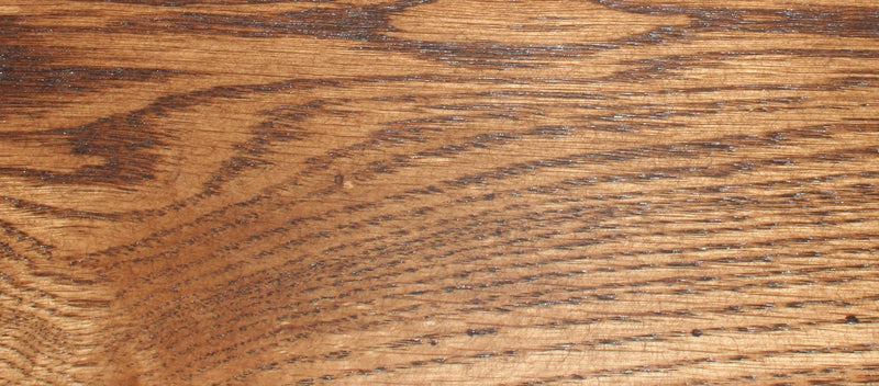 Close-up of Mission Oak wood grain in a rich, medium brown finish, showcasing the natural texture and durability of the bookcase material.